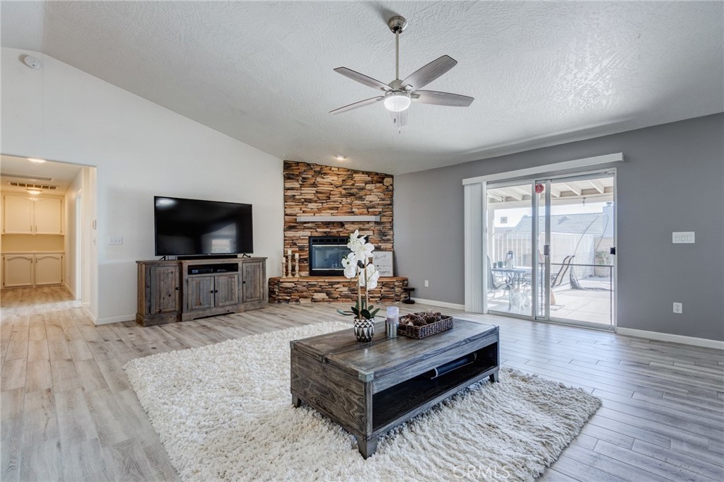 19783 Lara Lane Apple Valley, CA 92308 - Photo 30 of 42 a living room with furniture and a flat screen tv