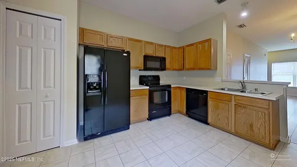 a kitchen with a refrigerator stove and microwave