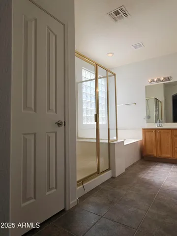 a spacious bathroom with a tub and shower