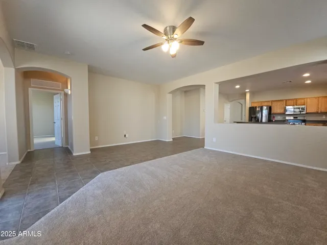 a view of a livingroom with a kitchen stove a sink and dishwasher