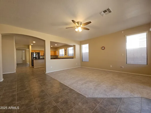 a view of a livingroom with a ceiling fan and window