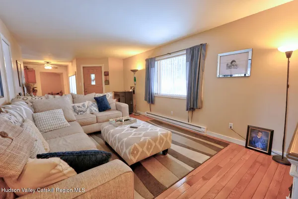 a bed sitting in a bedroom and chair next to a window
