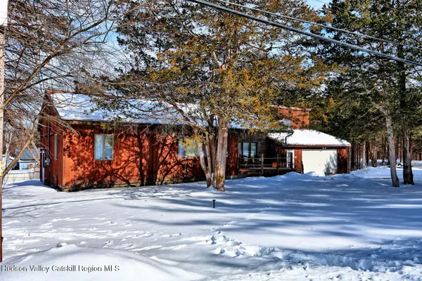 a view of a roof deck with wooden fence and a couple of chairs