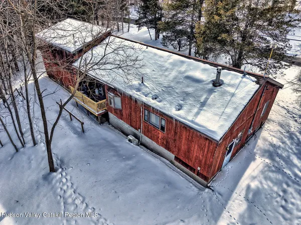 a view of a livingroom with workspace and a couch