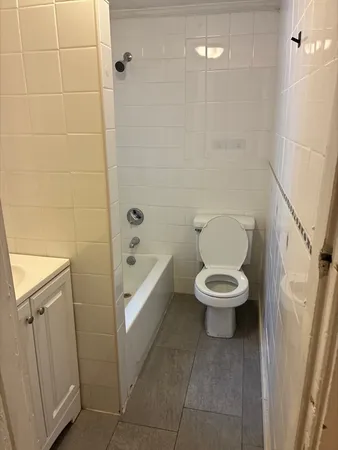 a white toilet sitting next to a bathroom sink