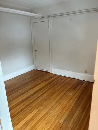 a view of a room with wooden floor