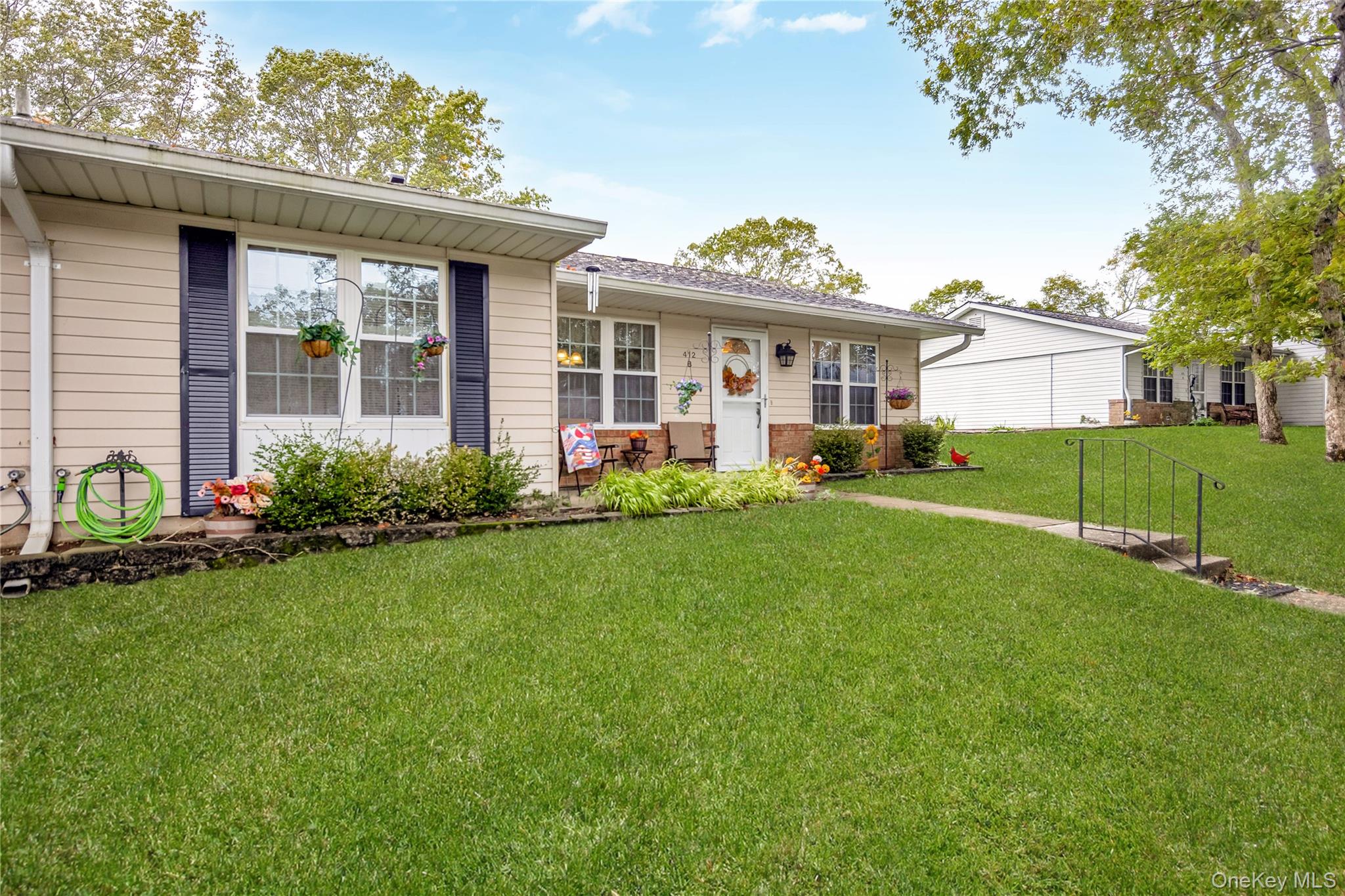 a front view of a house with garden