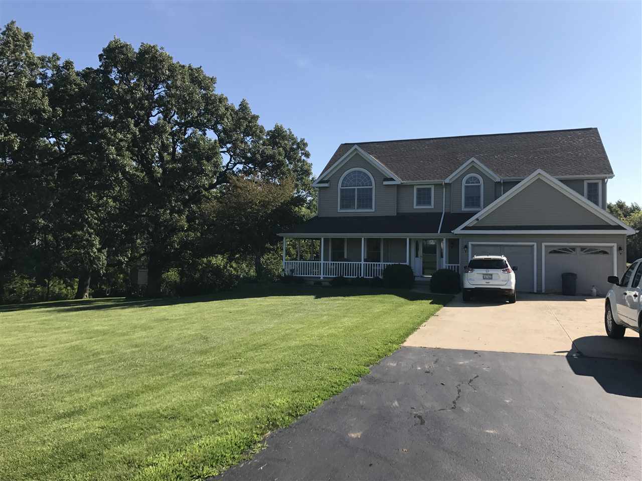 560 Rolling Hills Road Dixon, IL 61021 - Photo 2 of 3 a front view of a house with yard porch and tree