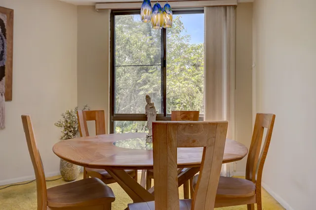 a view of a dining room with furniture and window