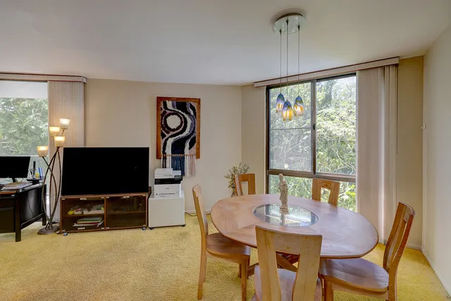 a view of a dining room with furniture window and outside view