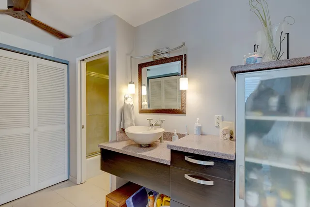 a bathroom with a sink mirror and a toilet