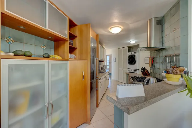 a kitchen with a refrigerator and a sink