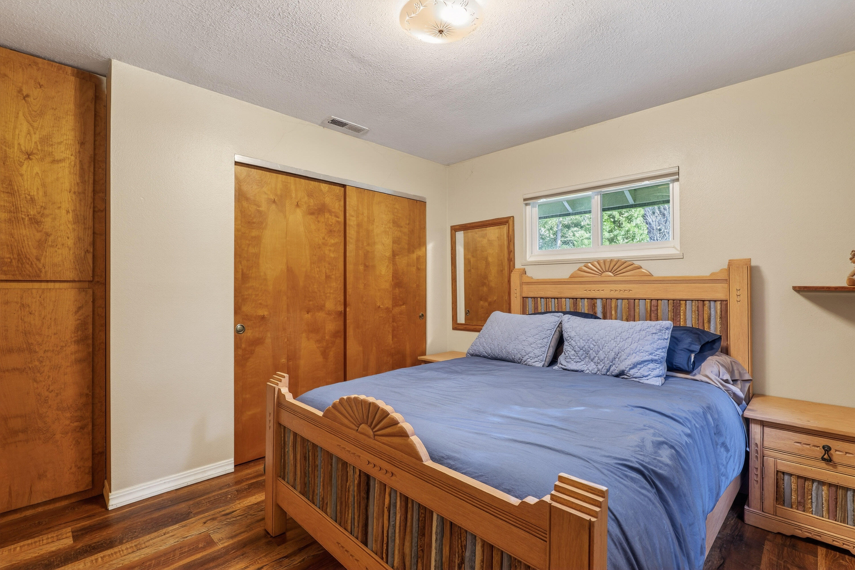 244 Riessen Road Grants Pass, OR 97526 - Photo 28 of 52 a bedroom with a bed and wooden floor
