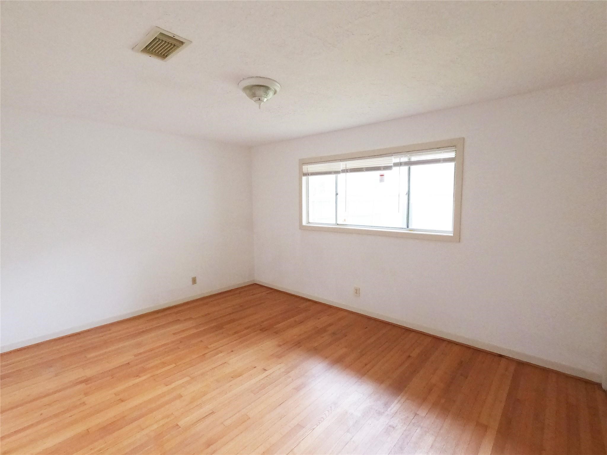 5231 Beechnut Street Houston, TX 77096 - Photo 11 of 19 an empty room with a window