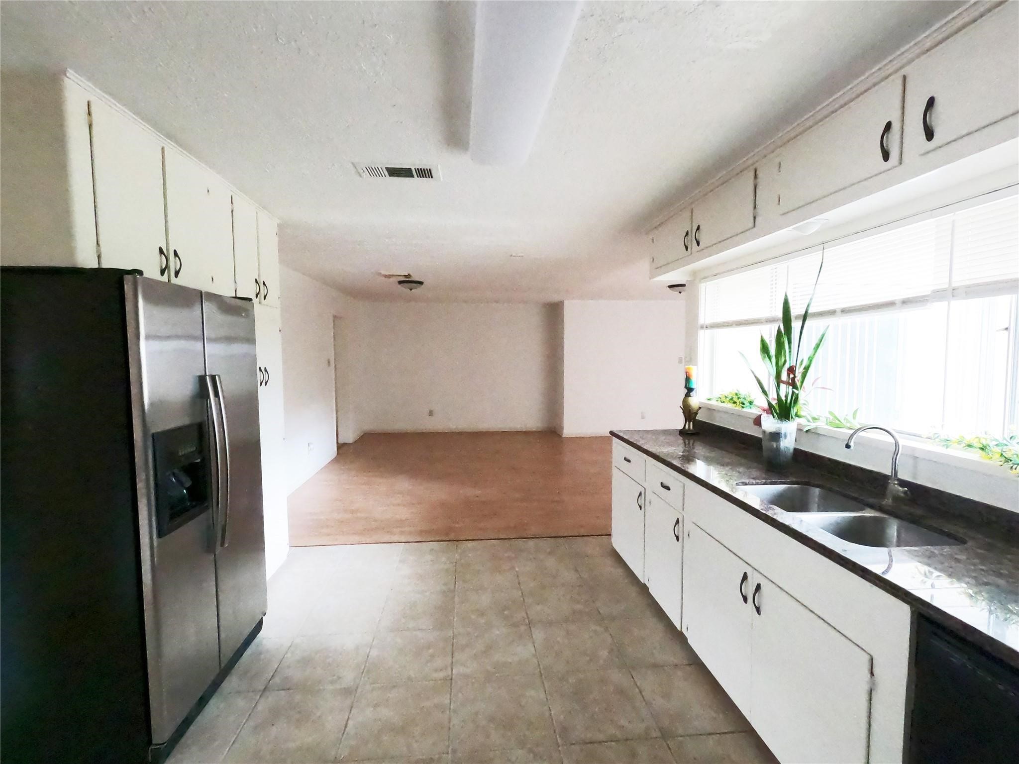 5231 Beechnut Street Houston, TX 77096 - Photo 15 of 19 a kitchen with a sink and refrigerator