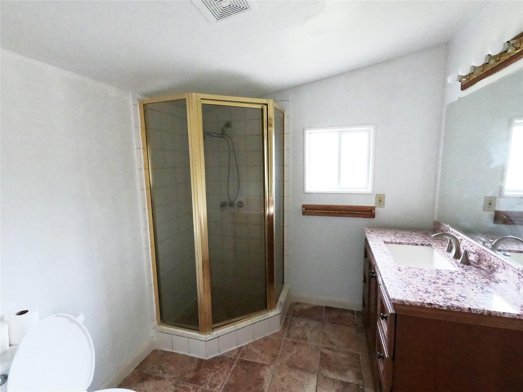 5231 Beechnut Street Houston, TX 77096 - Photo 17 of 19 a bathroom with a granite countertop sink and a mirror