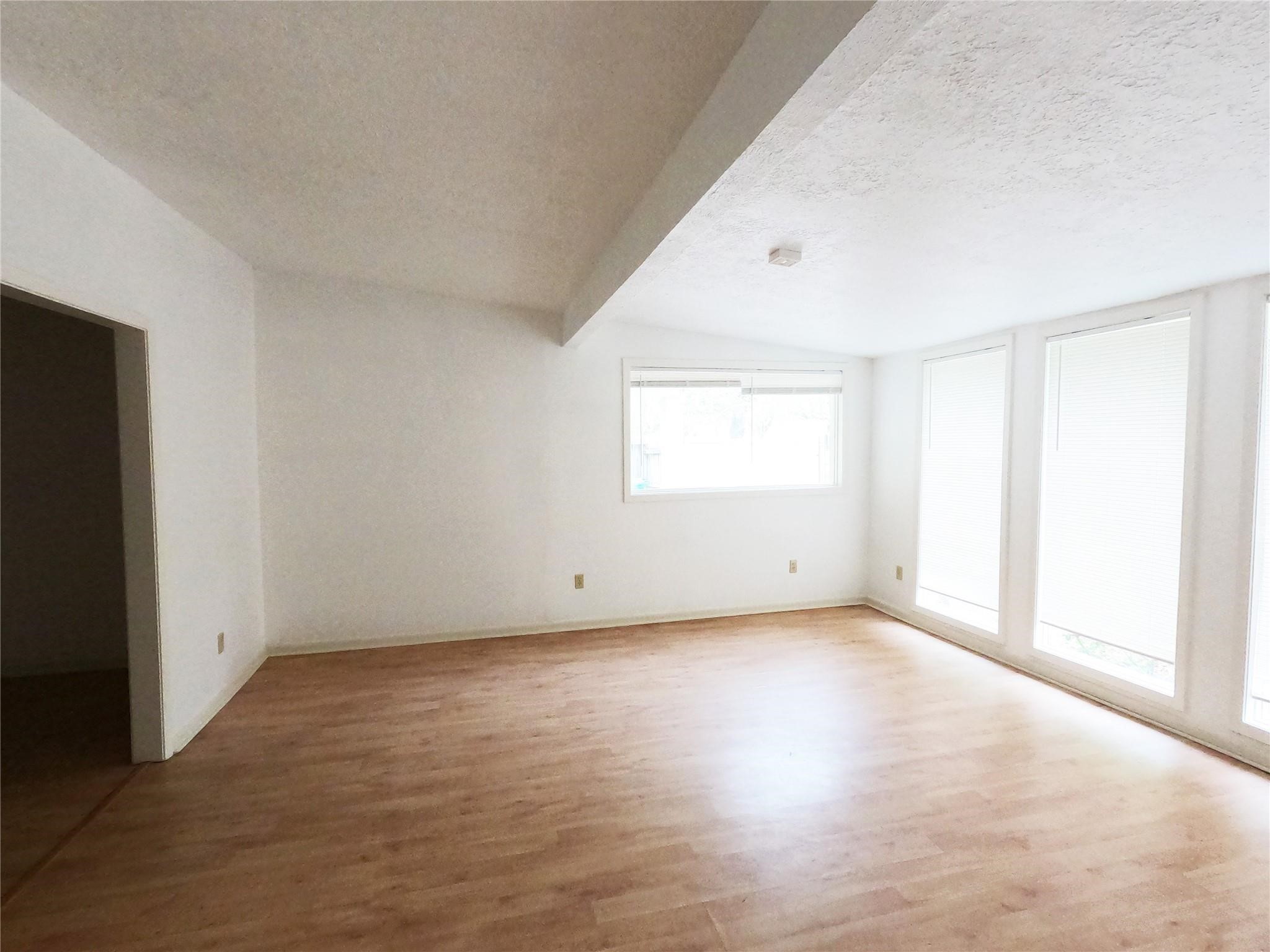 5231 Beechnut Street Houston, TX 77096 - Photo 4 of 19 an empty room with windows