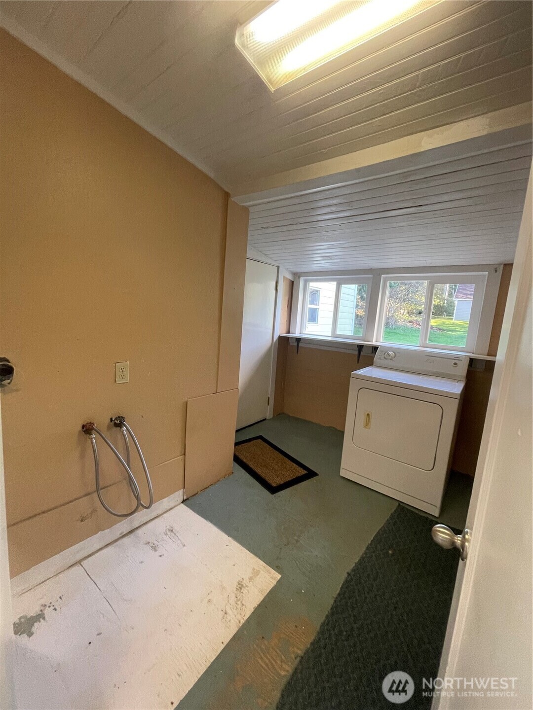 1052 Ballentine Street Raymond, WA 98577 - Photo 13 of 14 a living room with furniture and a floor to ceiling window