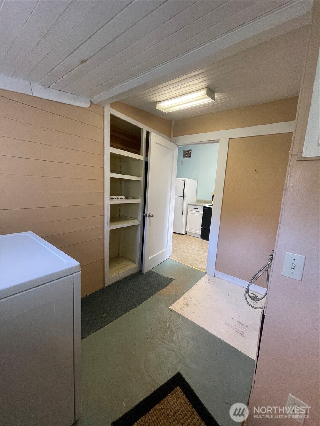 1052 Ballentine Street Raymond, WA 98577 - Photo 14 of 14 a view of a storage & utility room with a refrigerator