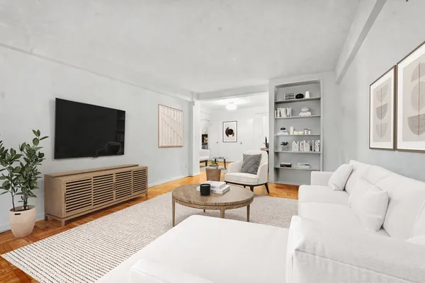 a living room with furniture a flat screen tv and a window