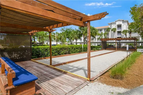 a view of a patio with a table chairs and a backyard