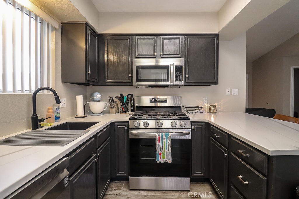 1330 Santa Fe Circle Needles, CA 92363 - Photo 13 of 28 a kitchen with stainless steel appliances granite countertop a sink stove and microwave
