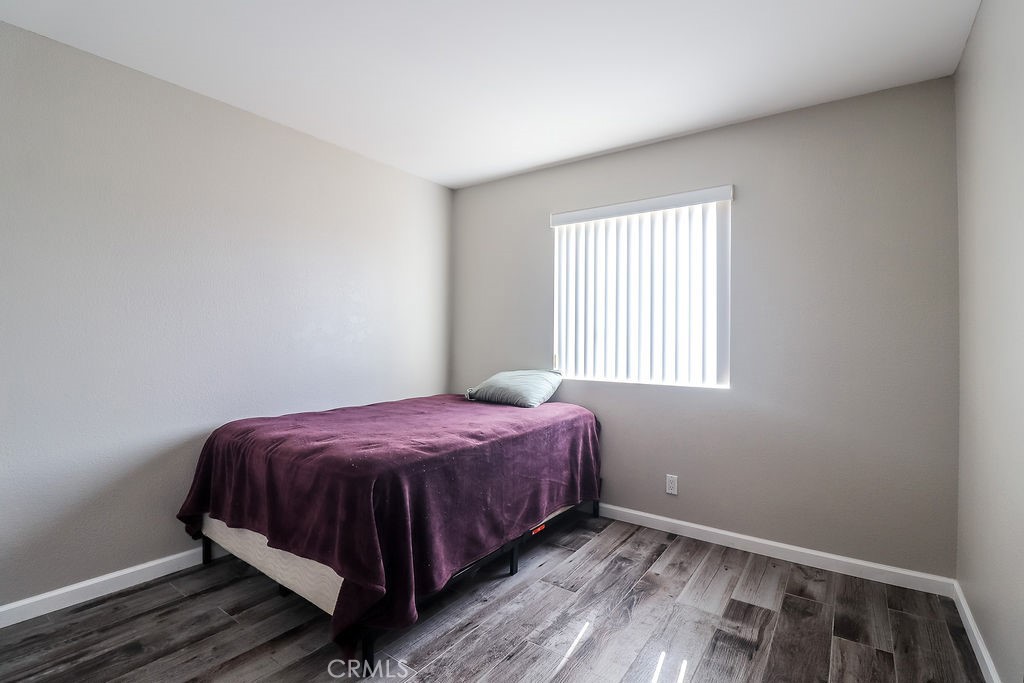 1330 Santa Fe Circle Needles, CA 92363 - Photo 18 of 28 a bedroom with a bed and wooden floor