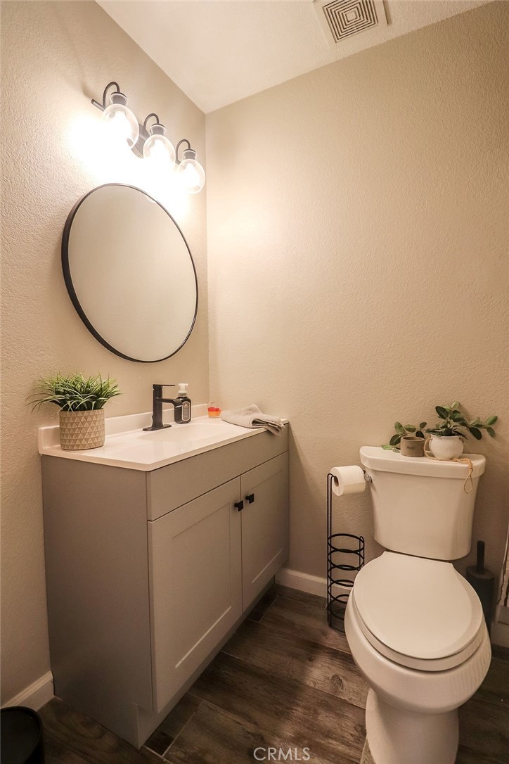 1330 Santa Fe Circle Needles, CA 92363 - Photo 19 of 28 a bathroom with a toilet sink and mirror