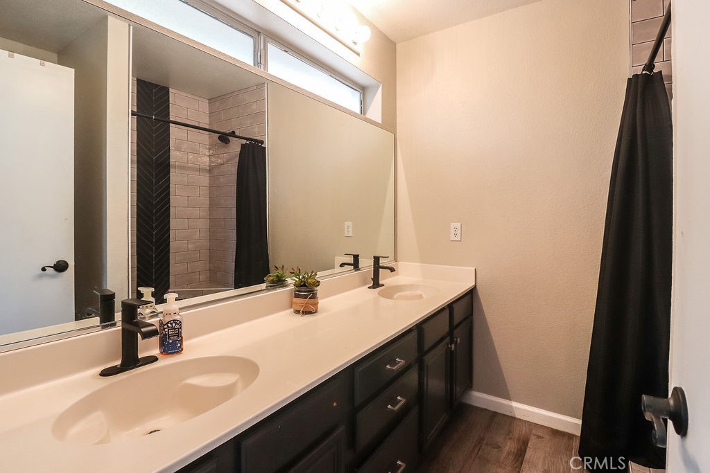 1330 Santa Fe Circle Needles, CA 92363 - Photo 24 of 28 a bathroom with a double vanity sink and a mirror