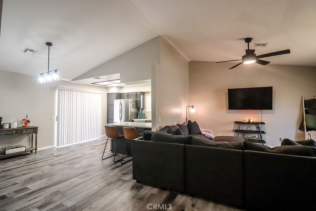 1330 Santa Fe Circle Needles, CA 92363 - Photo 7 of 28 a living room with furniture a flat screen tv and a chandelier