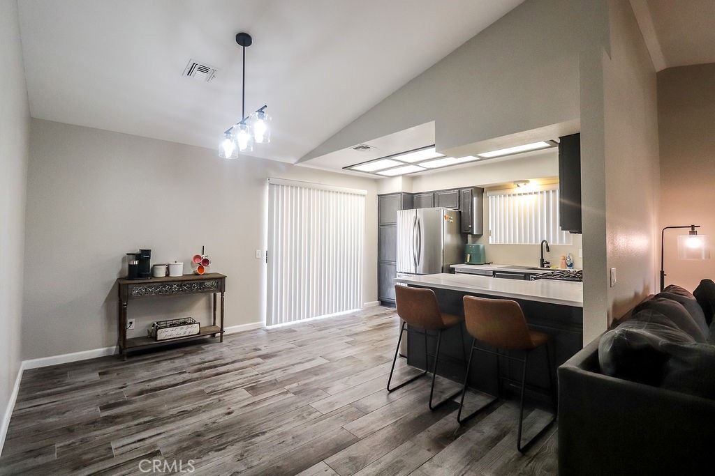 1330 Santa Fe Circle Needles, CA 92363 - Photo 8 of 28 a view of a livingroom with furniture a chandelier and wooden floor