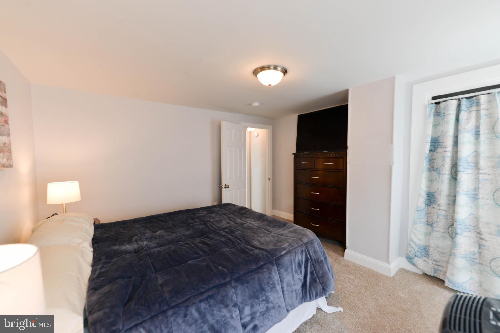 322 Ridgeway Street Gloucester City, NJ 08030 - Photo 11 of 22 a bedroom with a bed and a lamp