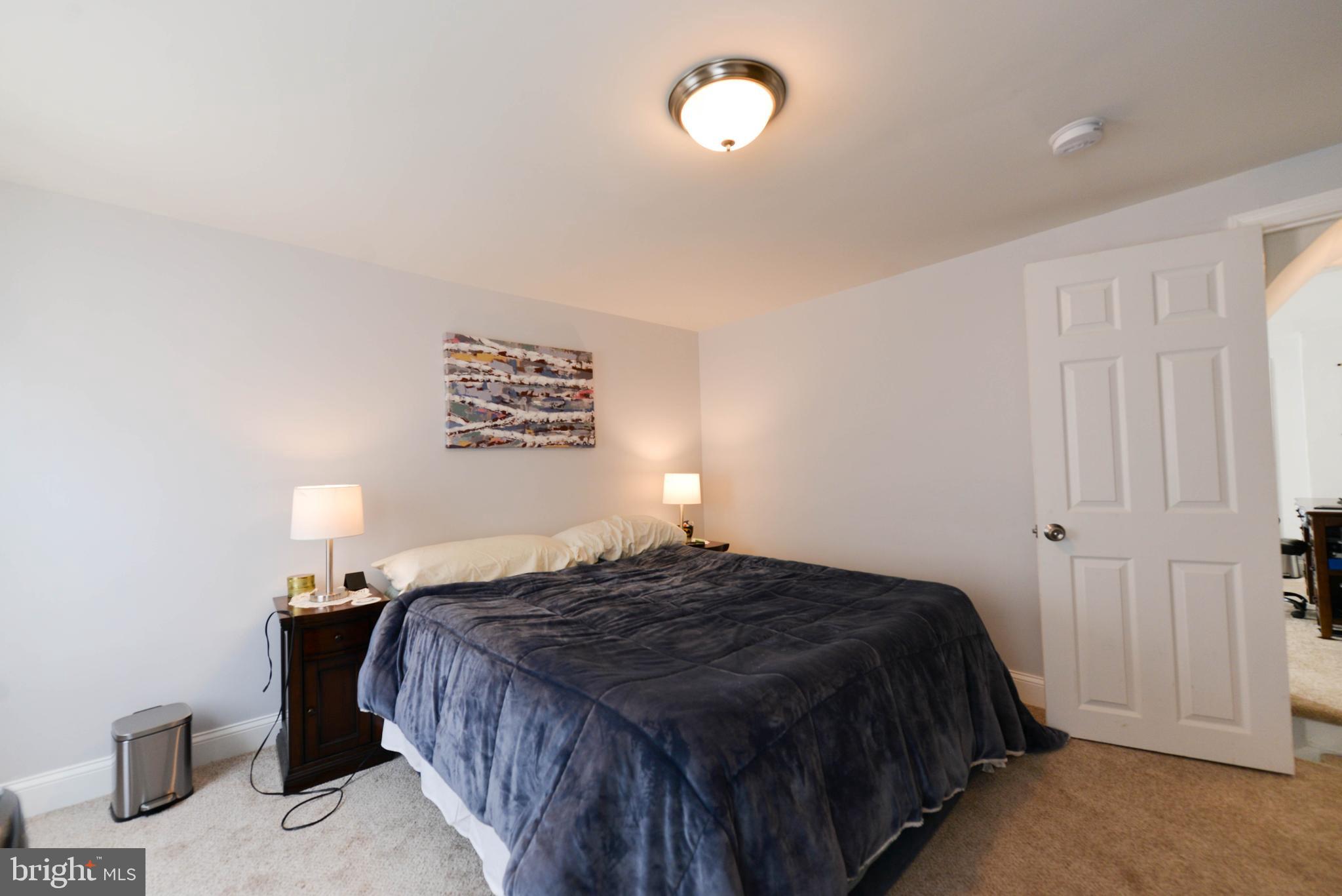 322 Ridgeway Street Gloucester City, NJ 08030 - Photo 12 of 22 a bedroom with a bed and a lamp with the table