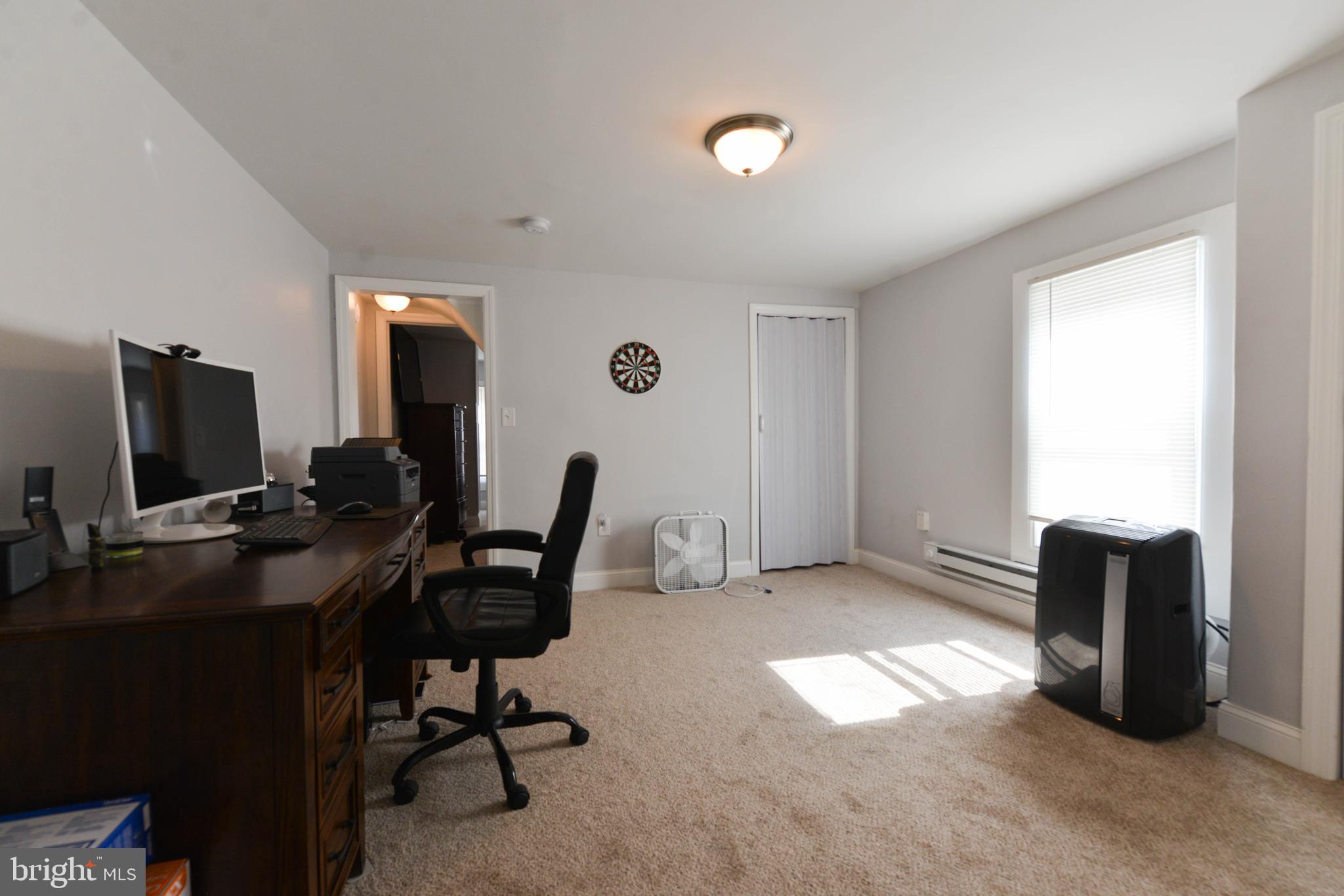 322 Ridgeway Street Gloucester City, NJ 08030 - Photo 13 of 22 a view of a workspace with furniture and a window