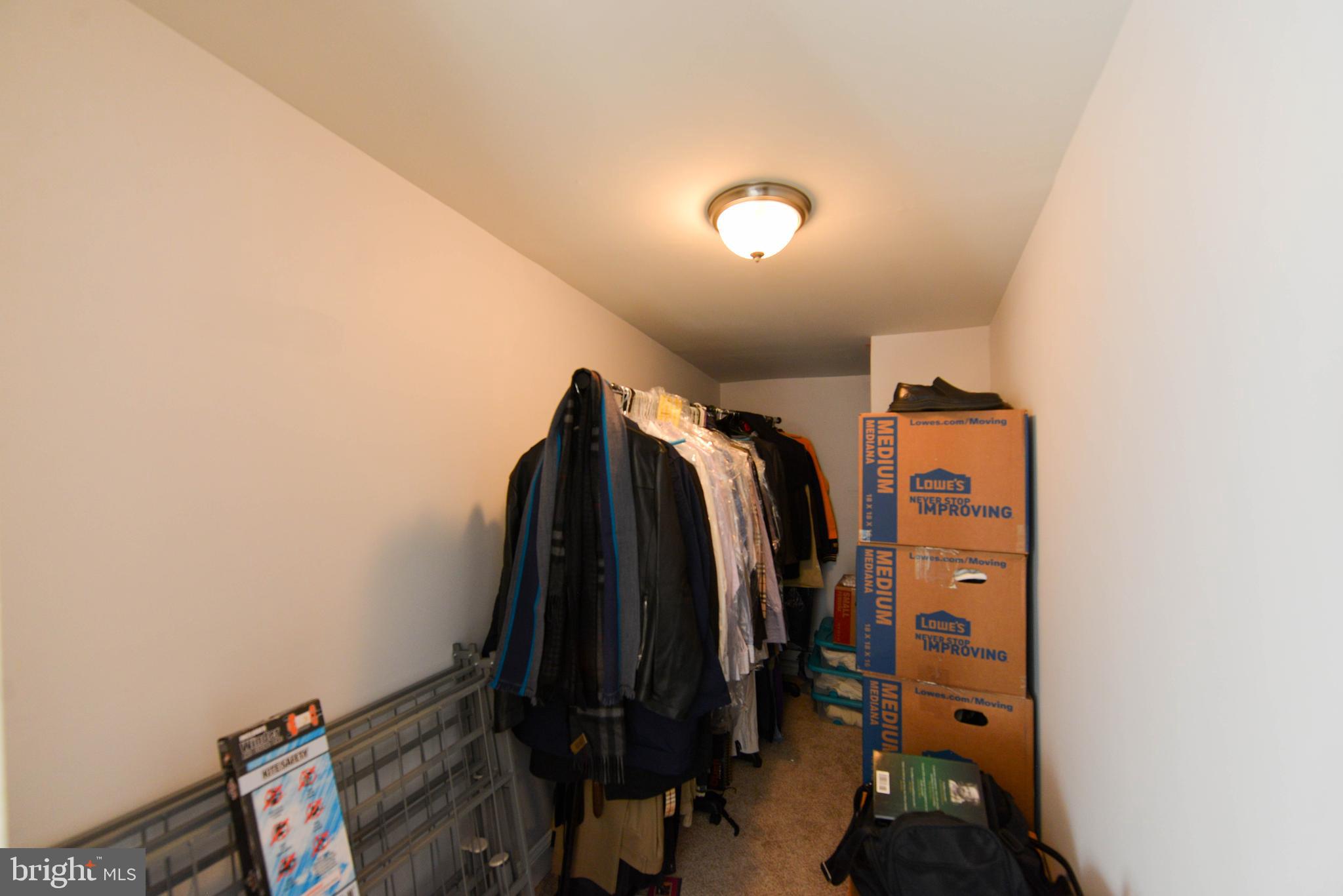 322 Ridgeway Street Gloucester City, NJ 08030 - Photo 17 of 22 a view of walk in closet with clothes and shoes