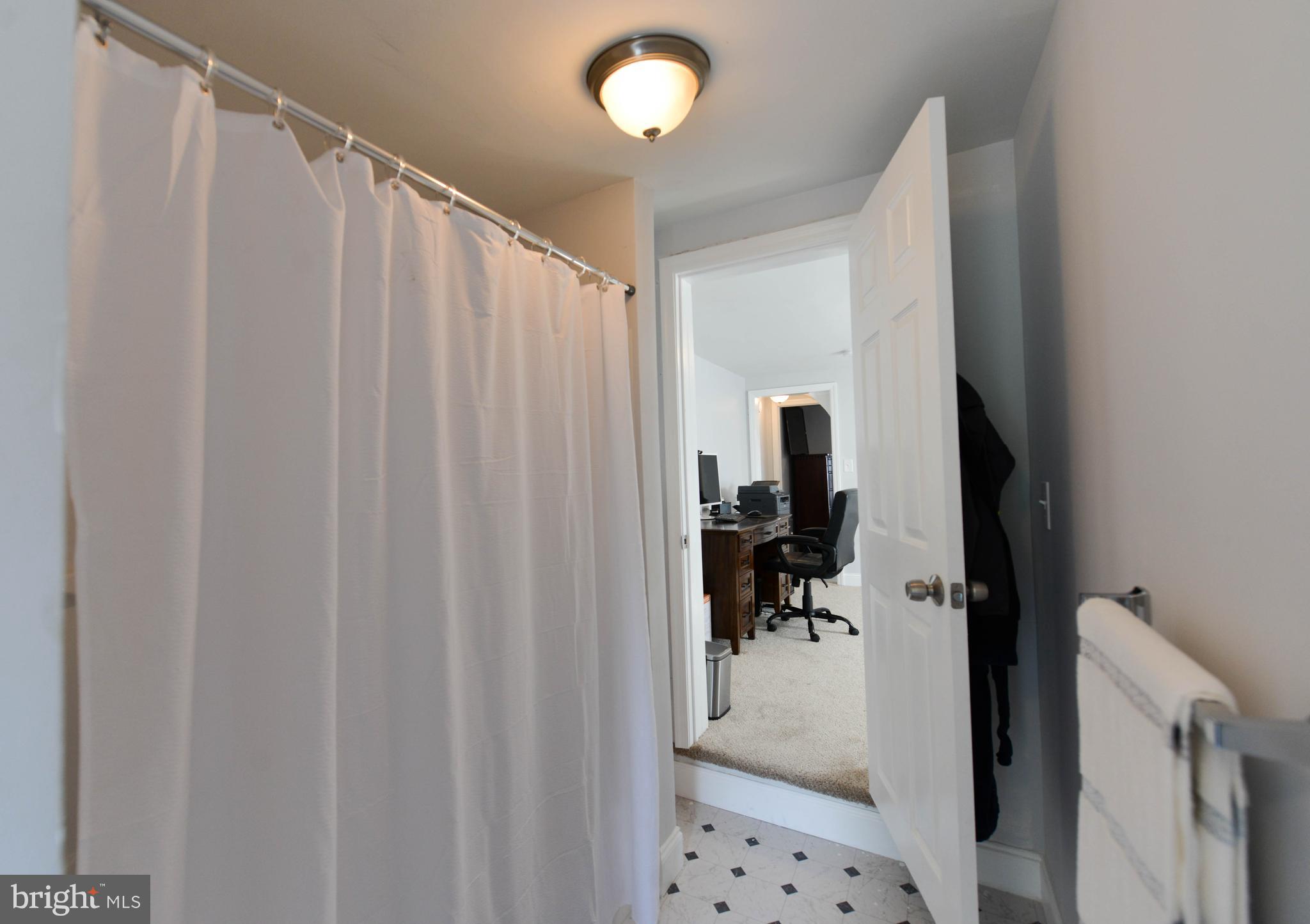 322 Ridgeway Street Gloucester City, NJ 08030 - Photo 18 of 22 a bathroom with a shower curtain and a sink
