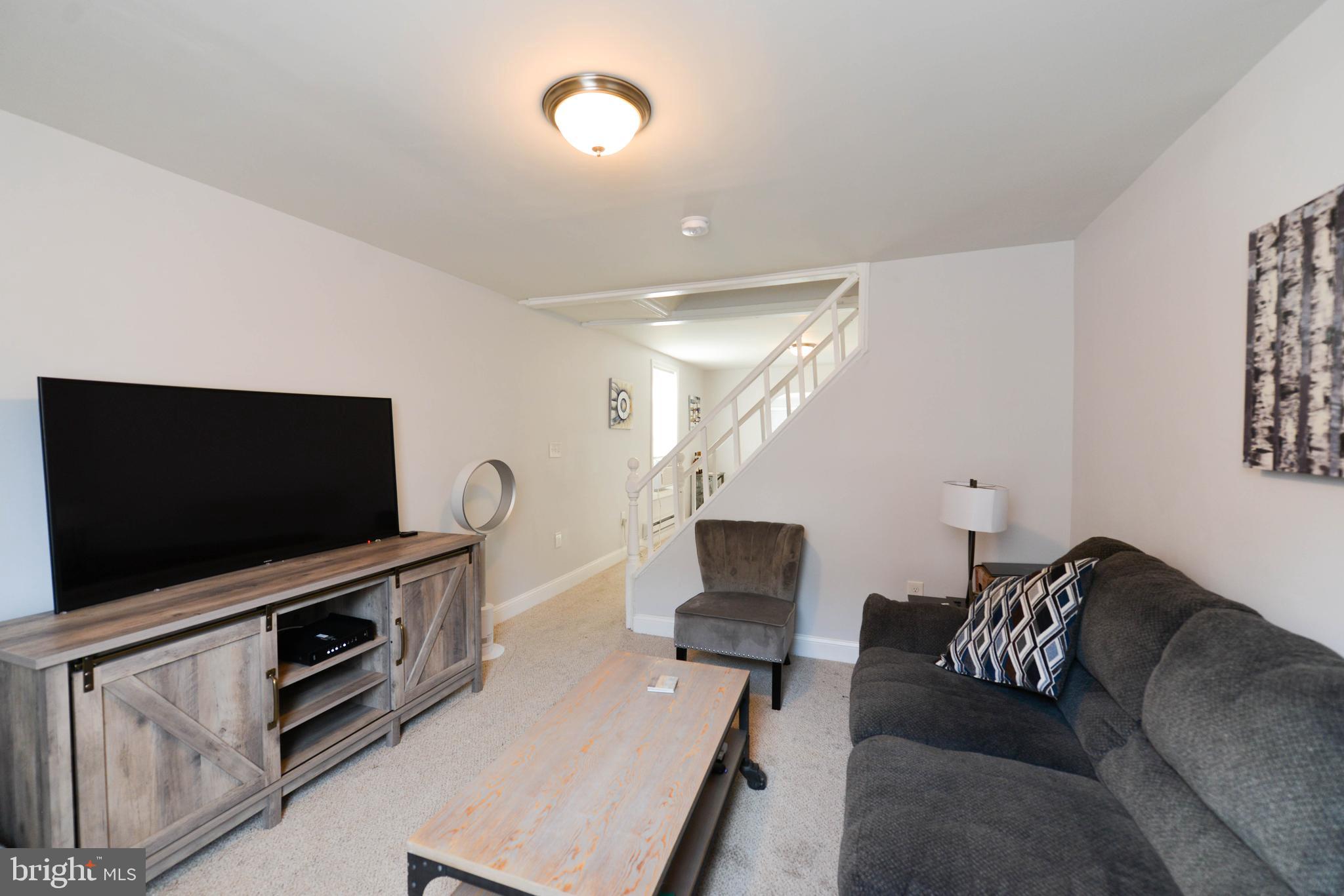 322 Ridgeway Street Gloucester City, NJ 08030 - Photo 5 of 22 a living room with furniture and a flat screen tv