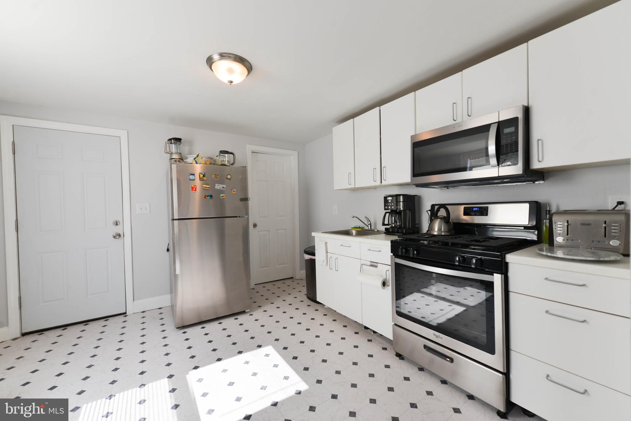 322 Ridgeway Street Gloucester City, NJ 08030 - Photo 10 of 22 a kitchen with stainless steel appliances granite countertop a refrigerator sink and stove
