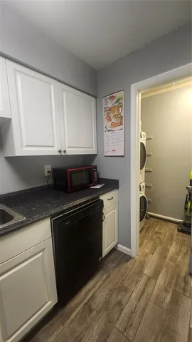 a kitchen with granite countertop a refrigerator and a sink