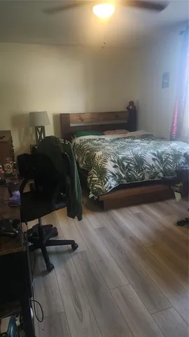 a bed sitting in a room next to a lamp