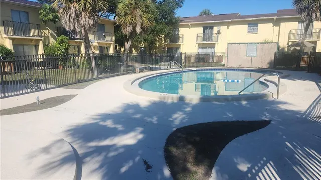 a view of a patio with table and chairs with wooden floor and fence