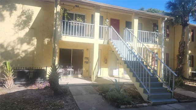 a view of front door of house with stairs
