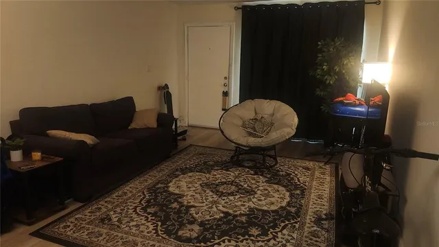 a living room with furniture and a mirror