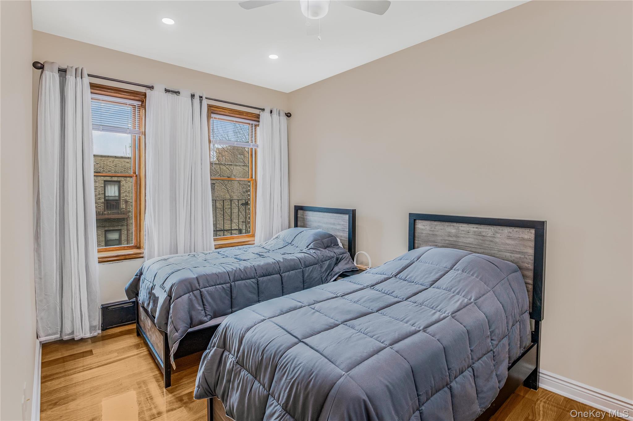 43-47 44th Street, Unit 3F Queens, NY 11104 - Photo 13 of 17 a bedroom with two beds and a large window