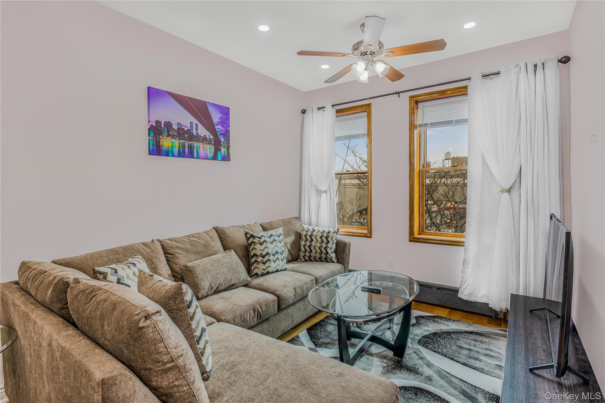 43-47 44th Street, Unit 3F Queens, NY 11104 - Photo 3 of 17 a living room with furniture ceiling fan and a window