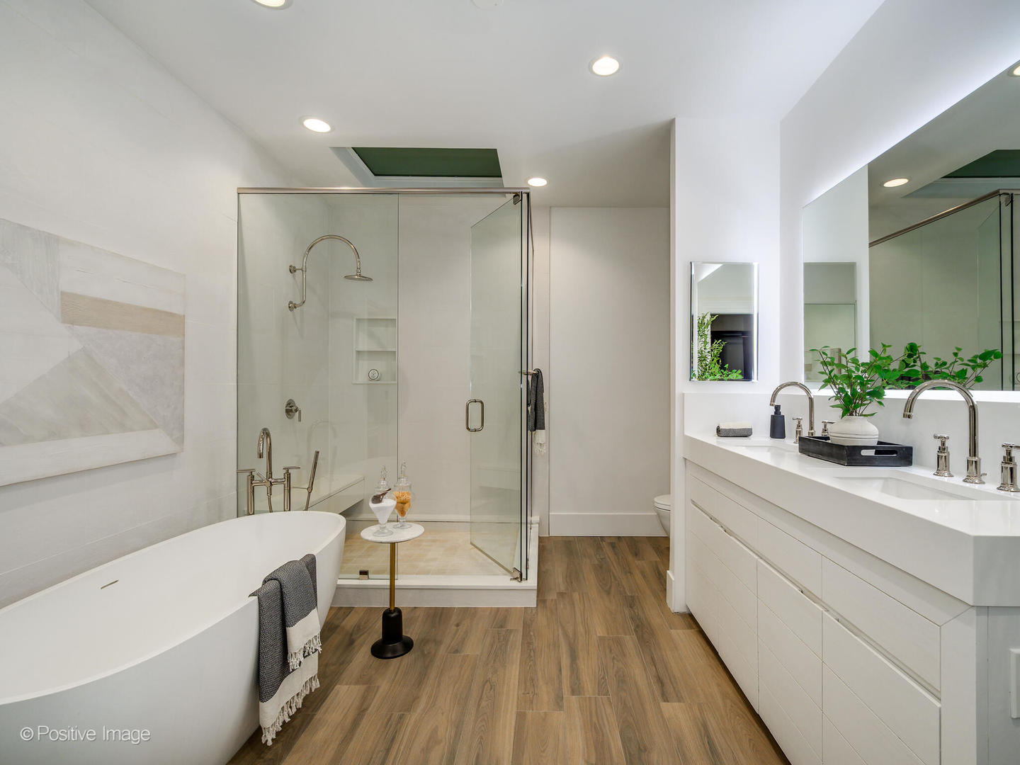 37 East Elm Street Chicago, IL 60611 - Photo 20 of 32 a bathroom with a double vanity sink a mirror a bathtub and shower