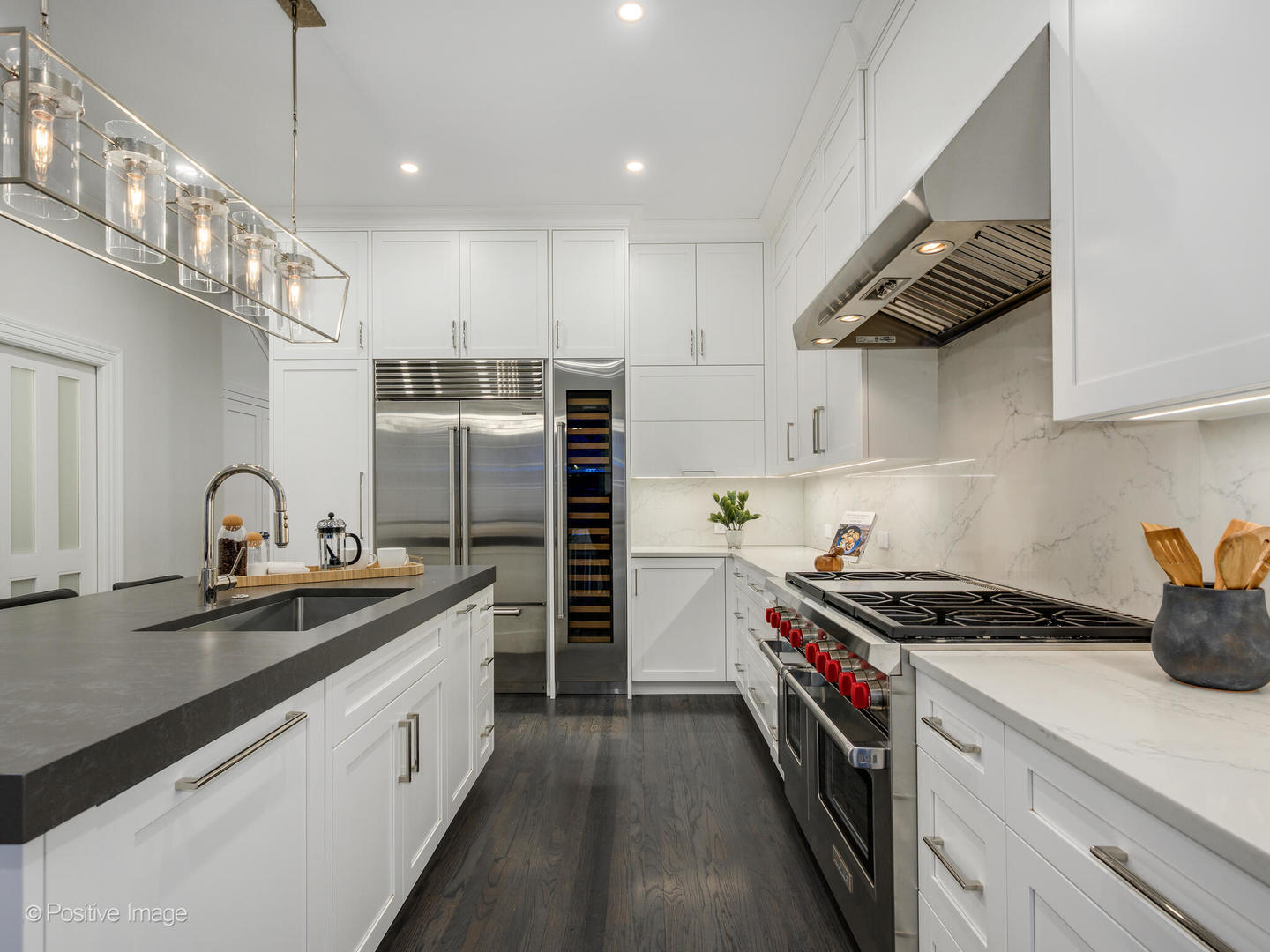37 East Elm Street Chicago, IL 60611 - Photo 10 of 32 a kitchen with stainless steel appliances a sink a stove and cabinets