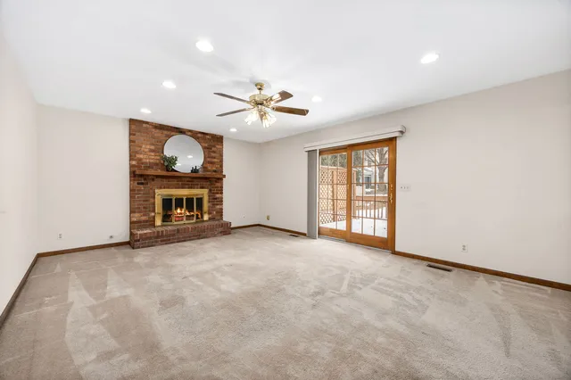 an empty room with furniture and a fireplace