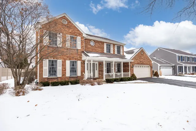 a front view of a residential houses with snow