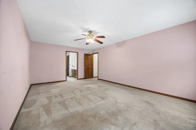 a spacious bathroom with a double vanity sink and a mirror